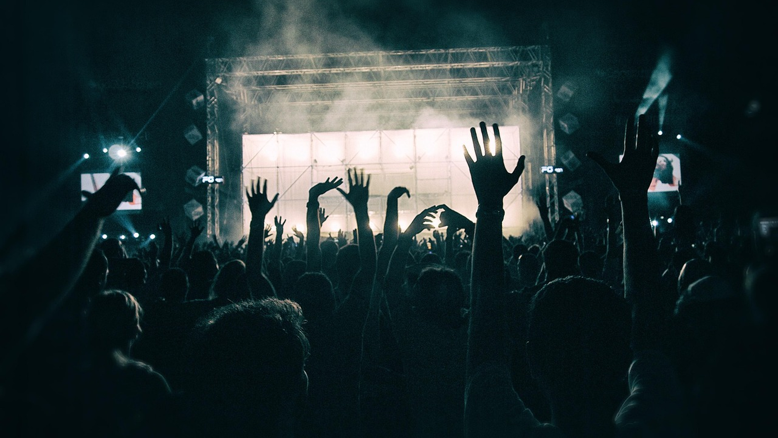 Crowd dancing at a retro disco party under colourful lights