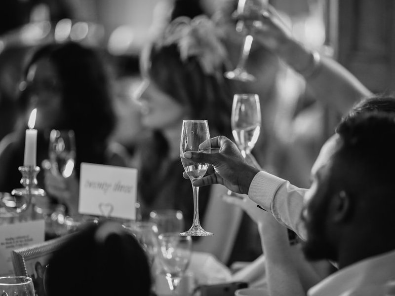 Wedding guests raising glasses in a toast