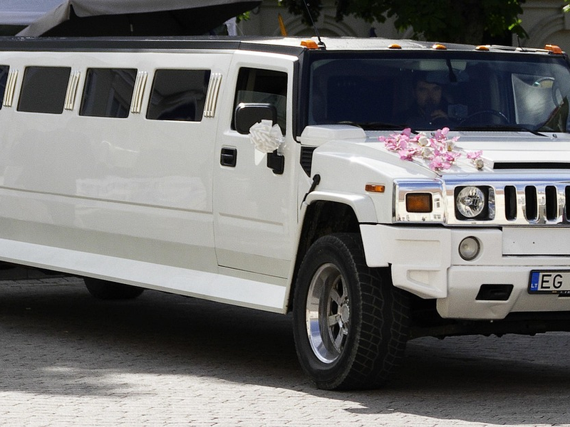 White wedding limousine with ribbons