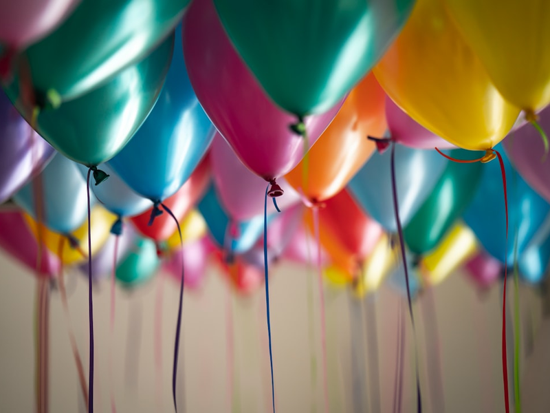 Children playing with balloons at a party